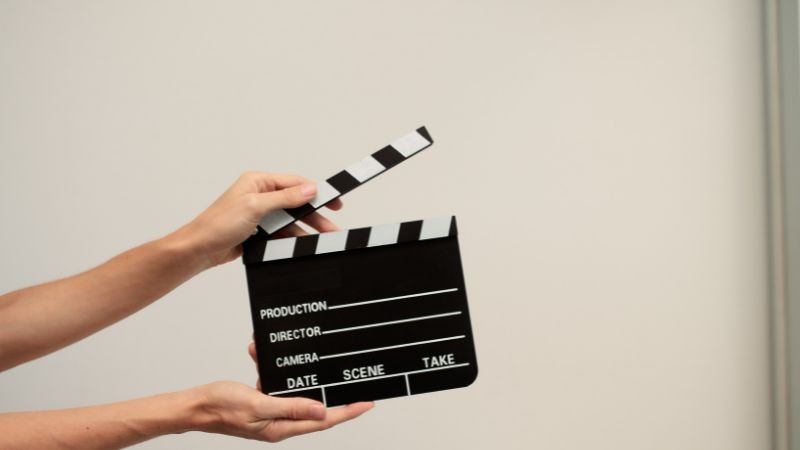 hands holding movie marker